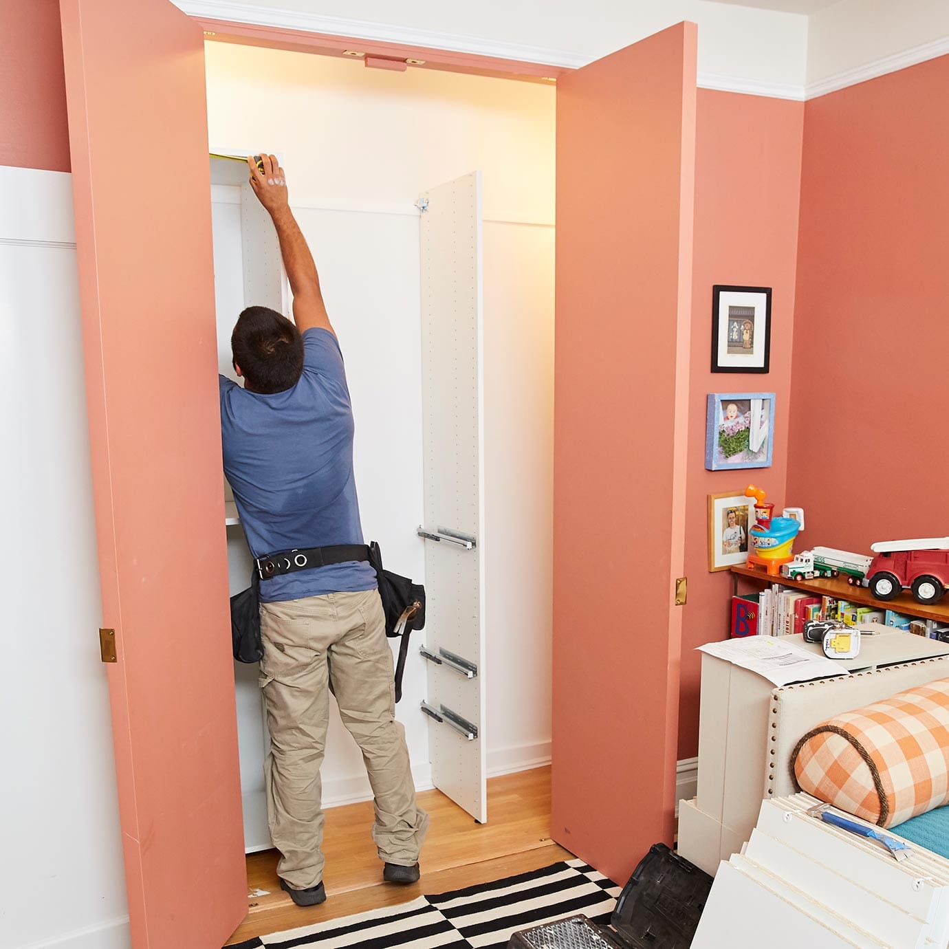 Installer adding in custom shelving to reach in closet designed by California Closets